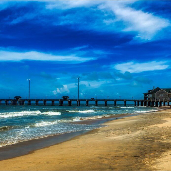 A beach with waves coming in from the ocean.