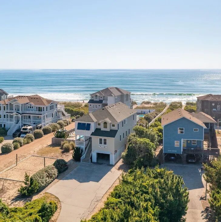 A view of houses and the ocean from above.